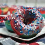 Captain America Donuts with red, white and blue sprinkles on a plate