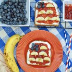 American flag toast with cream cheese, blueberries, strawberry jam and bananas