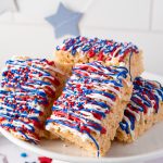 Patriotic, July 4th themed Rice Krispie treats stacked on a white plate