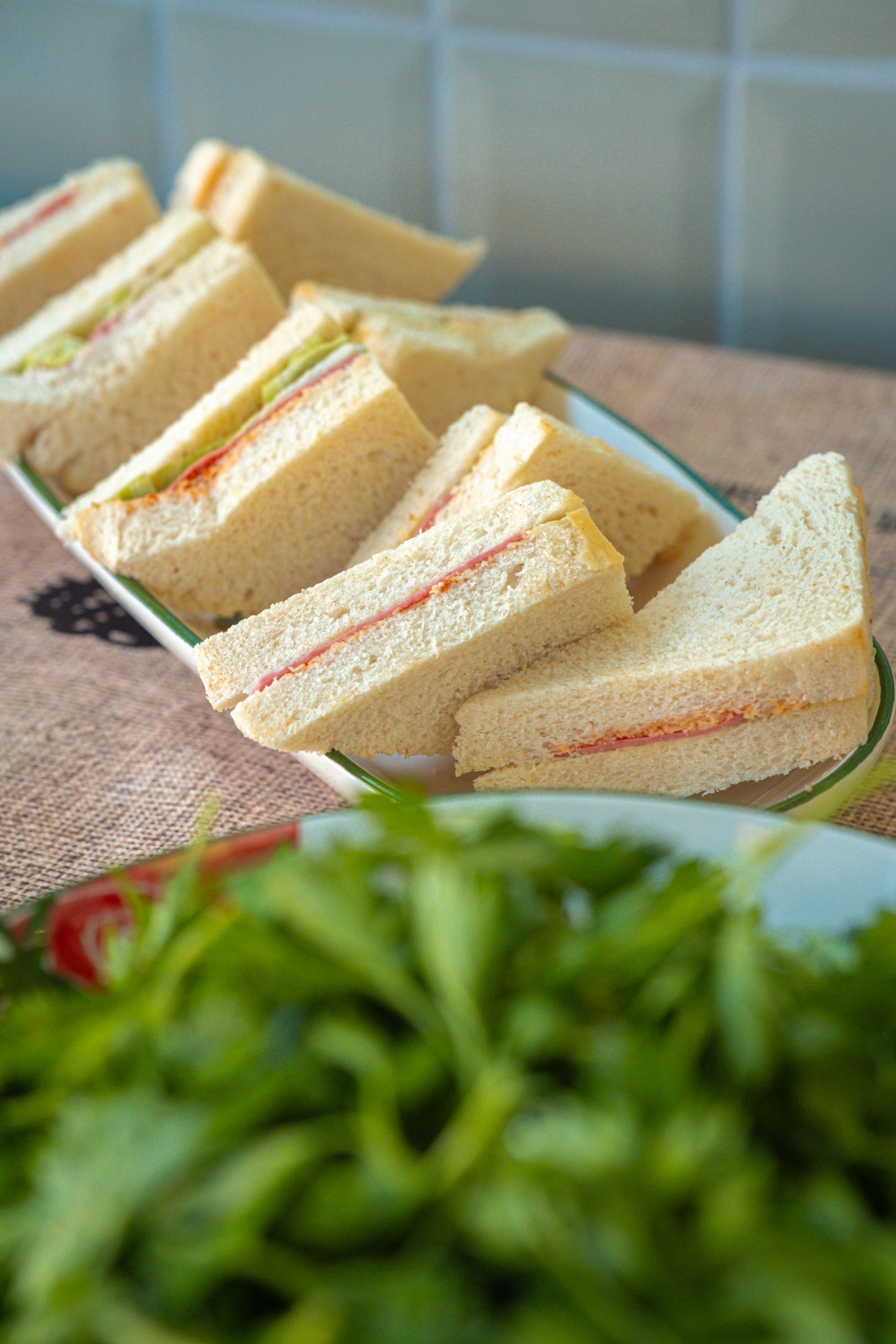 Tasty triangle sandwiches on a platter, perfect for brunch or a quick snack.